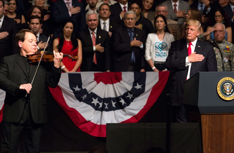 Cuban violinist Luis Haza plays the U.S. national anthem during Donald Trump’s speech at the Manuel Artime Theater, Friday June 16. Photo: Cristobal Herrera / EFE.