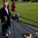 Donald Trump speaks with the press when leaving the White House on November 21, 2017 en route to Mar-a-Lago in Palm Beach, Florida, for Thanksgiving Day. First Lady Melania Trump and their son Barron wait in the background. Photo: Evan Vucci / AP.