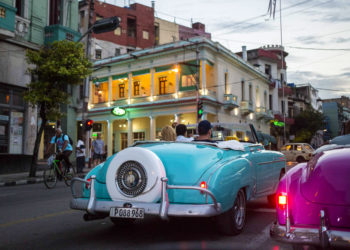 Tourists in vintage American convertibles in Havana. Photo: Desmond Boylan / AP.