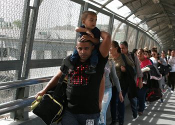 In this photograph from April 29, 2019, Cuban migrants are escorted by Mexican immigration authorities in Ciudad Juárez, Mexico. (AP Photo/Christian Torres)