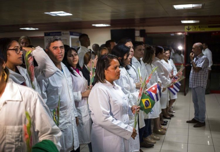 Cuban doctors wait to meet with Cuban President Miguel Díaz-Canel after landing in Havana on Friday, November 23, 2018. Photo: Desmond Boylan / AP.