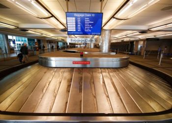 In this March 20, 2020 photo, an empty luggage carousel spins at Denver International Airport, Colorado. Photo: David Zalubowski / AP.