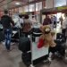 Cubans who arrived on the island, with a single suitcase weighing 23 kilograms each, waiting at Havana’s José Martí airport for their transfer to an isolation center for the quarantine because of COVID-19 before going home. Photo: Mónica Rivero.