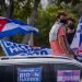 Some young people listen to the speech of the former U.S. President Barack Obama, sitting on the roof of a car decorated with posters that say “Cubans with Biden Harris,” during a rally in support of Democratic candidate for the presidency Joe Biden, in the Biscayne Campus of Florida International University (FIU) in Miami, Florida. Photo: Giorgio Viera/EFE.