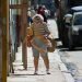 An elderly woman with bread and other purchases walks down a street in Havana during the outbreak of COVID-19 in January 2021. Photo: Otmaro Rodriguez.