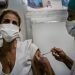 A nurse injects another nurse with a dose of the Soberana 02 COVID-19 vaccine candidate, as part of an intervention study with Cuban health personnel, at the Vedado Teaching Polyclinic, in Havana. Photo: Ramón Espinosa/AP/POOL.