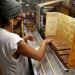 A woman works in the production of cigars, in Tabacuba, in Havana (Cuba). Photo: EFE/Yander Zamora.