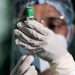 A nurse prepares to apply a COVID-19 vaccine.| Archive