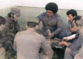 Noel Nicola (in front, in profile), Vicente Feliú, Pablo Milanés and Silvio Rodríguez, along with others present, around a domino table in Luanda, Angola, 1976.