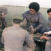 Noel Nicola (in front, in profile), Vicente Feliú, Pablo Milanés and Silvio Rodríguez, along with others present, around a domino table in Luanda, Angola, 1976.