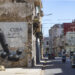 A car passes in front of graffiti on San Lázaro Street, in Havana (Cuba). Photo: EFE/Yander Zamora.