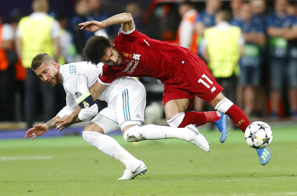 Sergio Ramos (izquierda) del Real Madrid comete una falta a Mohamed Salah del Liverpool en la final de la Liga de Campeones, en Kiev, Ucrania, el sábado 26 de mayo de 2018. (AP Foto/Efrem Lukatsky)