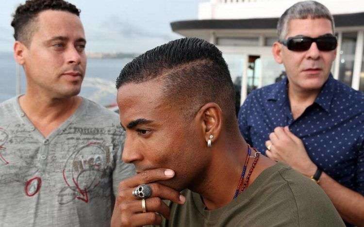 Fotografía del 22 de junio de 2016 de los integrantes del grupo de hip hop cubano Orishas, Yotuel Romero (c), Roldán González (d) e Hiram Riverí (i), durante una entrevista con Efe el en La Habana. Foto: Alejandro Ernesto / EFE.