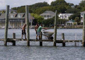 Desmantelan un muelle con la esperanza de salvarlo de la crecida antes de la llegada del huracán Florence, en Swansboro, Carolina del Norte, el 11 de septiembre de 2018. Foto. Tom Copeland / AP.