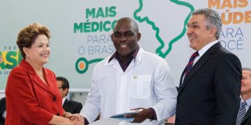 La expresidenta Dilma Rousseff junto a un médico cubano y al Ministro de Salud de su gobierno, Alexandre Padilha, durante la oficialización legal del programa "Más Médicos" en 2013. Foto: Roberto Stuckert Filho/ PR / Archivo.