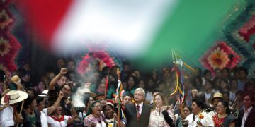 El nuevo presidente mexicano, Andrés Manuel López Obrador, al centro, sostiene un bastón de mando durante una ceremonia tradicional indígena en el Zócalo de la Ciudad de México el sábado 1ro de diciembre de 2018. A la derecha aparece de pie su esposa, Beatriz Gutiérrez Müller. Foto: Eduardo Verdugo / AP.