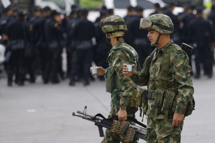 Soldados colombianos sostienen una taza de café al llegar al puente internacional Simón Bolívar en La Parada, cerca de Cúcuta, Colombia, en la frontera con Venezuela, el domingo 24 de marzo de 2019. Foto: Fernando Vergara / AP.