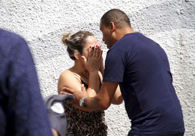 Un hombre conforta a una mujer en las afueras de la Escuela Estatal Raul Brasil en Suzano, Brasil, el miércoles, 13 de marzo del 2019. Dos adolescentes con capuchas abrieron fuego en una escuela pública el miércoles en el sur de Brasil, matando a seis personas antes de suicidarse, dijeron las autoridades. (Mauricio Sumiya/Futura Press via AP)