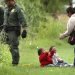 Una hondureña y sus dos hijos permanecen cerca de agentes de la Patrulla Fronteriza 10 de mayo de 2019 en el río Grande, cerca de Eagle Pass, en Texas, donde numerosas personas estaban cruzando a suelo estadounidense desde México en balsas. Foto: Bob Owen / The San Antonio Express-News vía AP.