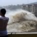 Un hombre graba con su celular el fuerte oleaje causado por la cercanía del tifón Lekima, en la ciudad de Wenling, en el la provincia oriental china de Zhejiang. (Han Chuanhao/Xinhua vía AP)