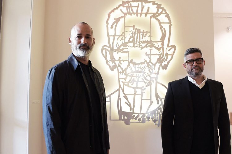 Los artistas cubanos Marco Castillo (i) y Dagoberto Rodríguez (d), del colectivo artístico "Los Carpinteros", frente a una obra de Castillo titulada "No es el Che, es Felicia" que forma parte de la exposición "Cuba Va!", que se exhibe en el museo Phillips Collection en Washington, Estados Unidos. Foto: Lenin Nolly / EFE.