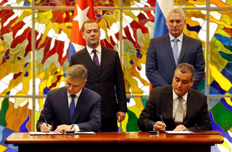 El presidente cubano Miguel Díaz-Canel Bermúdez (d-arriba), y el primer ministro de Rusia, Dmitri Medvédev (i-arriba), observan la firma un acuerdo bilateral entre ambos países en La Habana, el 3 de octubre de 2019. Foto: Ernesto Mastrascusa/ POOL/EFE.