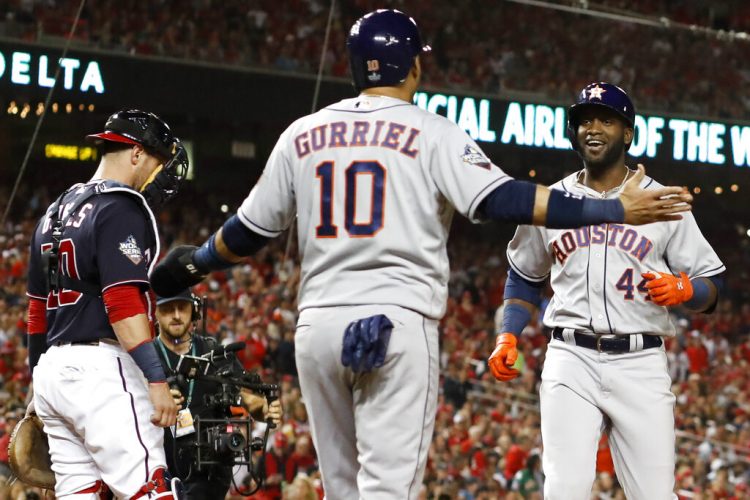 El cubano Yordan Álvarez, de los Astros de Houston, festeja con su compatriota y compañero Yuli Gurriel tras conectar un jonrón de dos carreras el domingo 27 de octubre de 2019, ante los Nacionales de Washington, en el quinto juego de la Serie Mundial (AP Foto/Jeff Roberson)