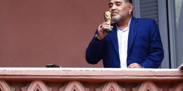 Diego Maradona sostiene una pequeña réplica de la Copa Mundial de la FIFA mientras la besa frente a los fanáticos en la casa del gobierno después de su reunión con el presidente argentino Alberto Fernández en Buenos Aires, Argentina, el jueves 26 de diciembre de 2019. Foto: AP/Marcos Brindicci