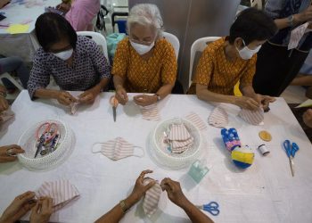 Voluntarios armando mascarillas de tela gratuitas en el Ministerio de Desarrollo Social y de Seguridad Humana en Bangkok, Tailandia, el miércoles 11 de marzo de 2020. Foto: AP/Sakchai Lalit.