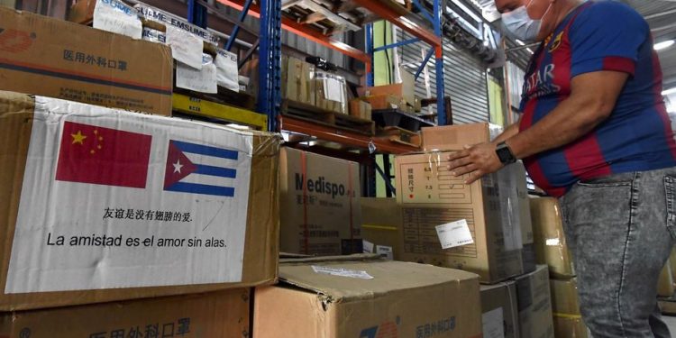 Un trabajador inspecciona cajas con insumos sanitarios llegados desde China para la contención de la pandemia por el nuevo coronavirus en Cuba. Foto: Joaquín Hernández / Xinhua / Archivo.