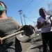 Manifestantes reunidas cerca de una barricada en llamas, durante una protesta pidiendo más ayuda alimentaria del gobierno en la pandemia del coronavirus, en un vecindario de Santiago de Chile, el martes 26 de mayo de 2020.  Foto: Esteban Félix/AP