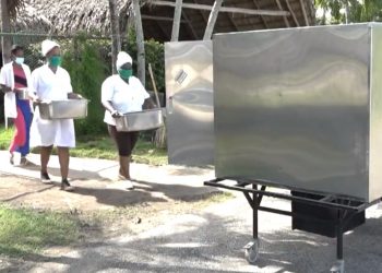 El robot cubano Palmiche (derecha) es utilizado para repartir alimentos en el centro de aislamiento de la CUJAE, en La Habana, durante la pandemia de coronavirus. Foto: Captura de pantalla.