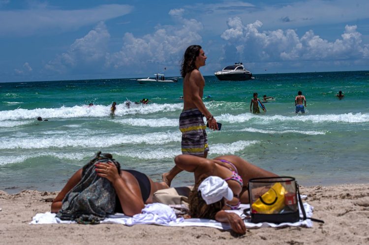 Decenas de personas disfrutan la playa este miércoles, en South Beach, en Miami La posible llegada a Florida de una tormenta tropical el fin de semana pone más presión a uno de los estados más golpeados por la COVID-19. Foto: Giorgio Viera / EFE.