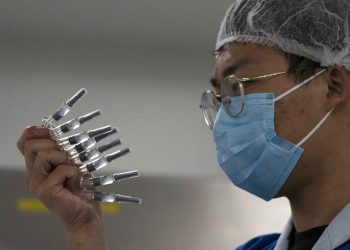 Un empleado inspecciona jeringas para la vacuna contra el COVID-19 producida por Sinovac en su fábrica de Beijing. Foto: Ng Han Guan/AP/Archivo.