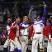 El jugador dominicano Johan Camargo alza los brazos para celebrar su jonrón solitario, en el quinto inning de su juego contra Puerto Rico, en la final de la Serie del Caribe en el estadio Teodoro Mariscal de Mazatlán, México, el sábado 6 de febrero de 2021. (AP Foto/Moisés Castillo)