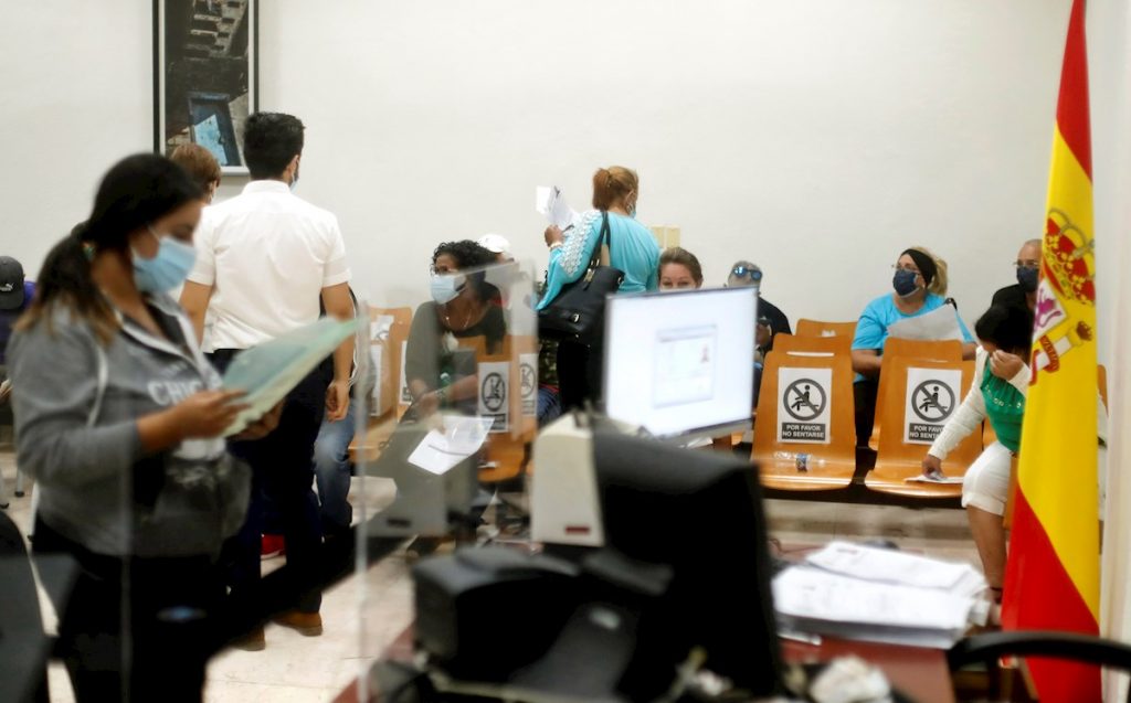 Varias personas adelantan tramites en la nueva sede del Consulado de España en La Habana. Foto: Ernesto Mastrascusa / EFE/Archivo.