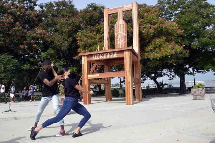 Acto de colocación de una silla gigante de madera, confeccionada por el grupo de artesanos Leo y Migue, en el Paseo de la Alameda de Santiago de Cuba. Foto: Miguel Rubiera / ACN.