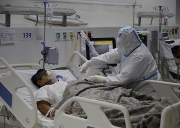 Un enfermero atiende a un paciente en la Unidad de Cuidados Intermedios para pacientes covid-19 del Hospital El Salvador, en San Salvador (El Salvador). Foto: EFE/Rodrigo Sura/Archivo.