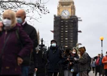 Decenas de personas esperan su turno para recibir una dosis de refuerzo de la vacuna anticovid en el hospital de St. Thomas, en Londres. Foto: Andy Rain/EFE/EPA.