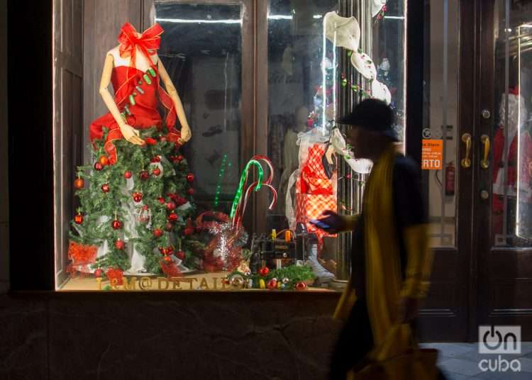 Un hombre camina por la calle Obispo de La Habana, fin de año 2022. Foto: Otmaro Rodríguez.