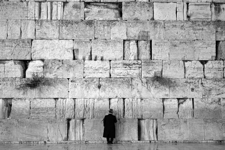 Un judío ultraortodoxo ora en el Kotel, de noche y bajo la lluvia. Foto: Alejandro Ernesto.