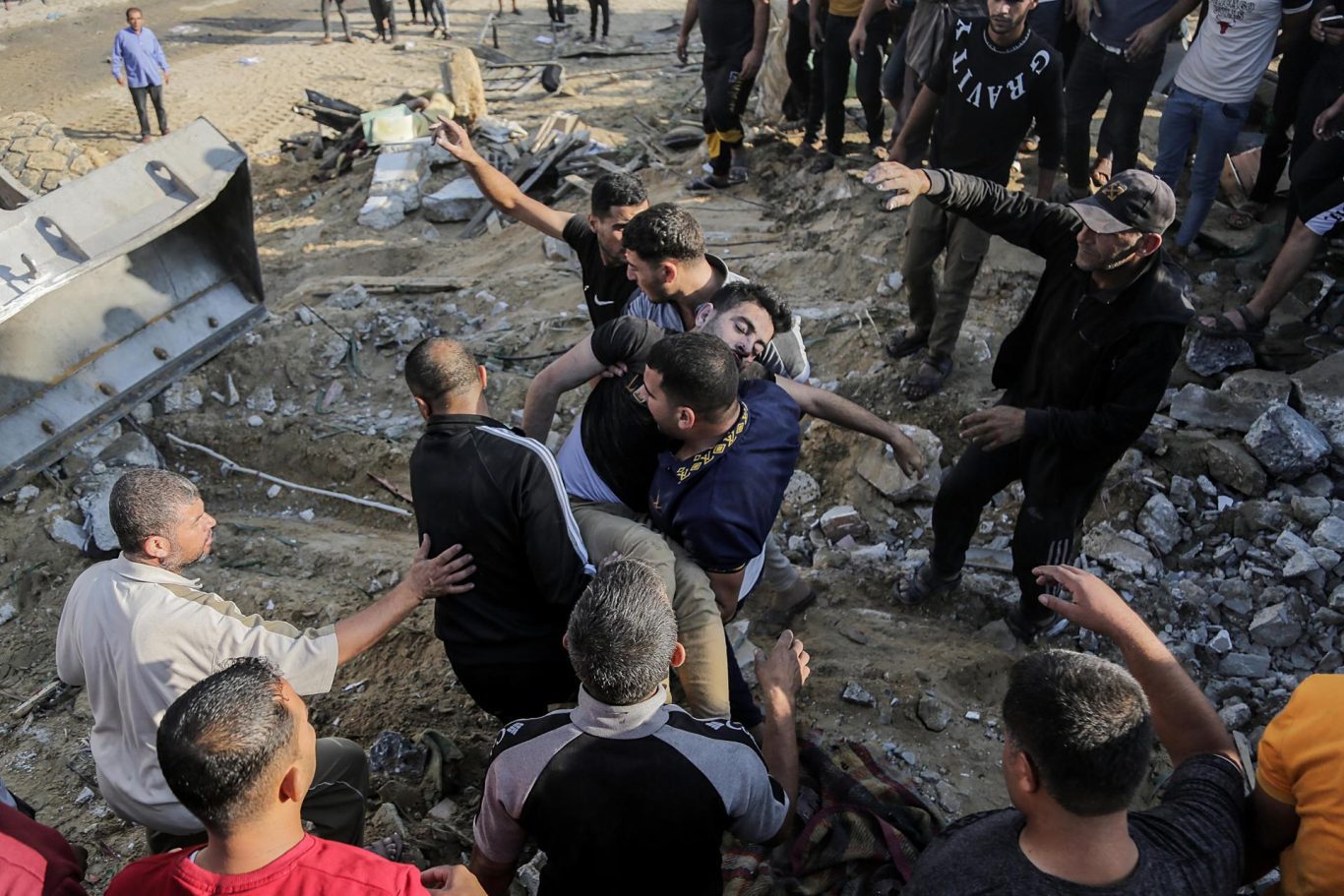 Palestinos buscan cuerpos y sobrevivientes en las ruinas de un edificio residencial destruido por bombardeo israelí, en el campo de refugiados de Khan Younis, sur de la Franja de Gaza, 16 de octubre de 2023. Foto: EFE/EPA/Haitham Imad. 