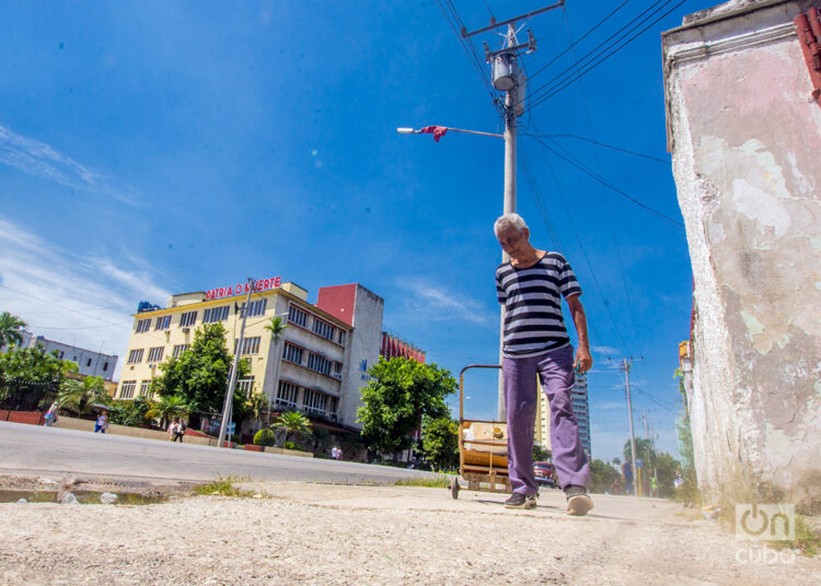 Un anciano arrastra una carretilla en el Vedado, en el municipio Plaza de la Revolución. Foto: Otmaro Rodríguez.