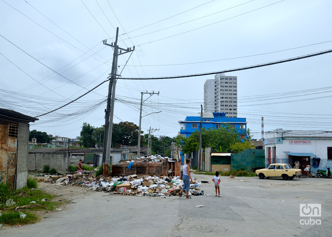 Basurero en la intersección de las calles San Martín y Línea del Ferrocarril, el barrio de San Martín, en el Cerro, La Habana. Detrás, la bodega del barrio, y más atrás, uno de los edificios de Infanta y Manglar. Foto: Otmaro Rodríguez.