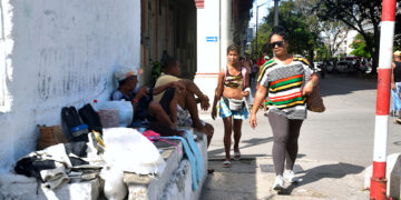 Unas mujeres transitan cerca de unos vendedores callejeros en la calle Reina, en La Habana. Foto: Otmaro Rodríguez.