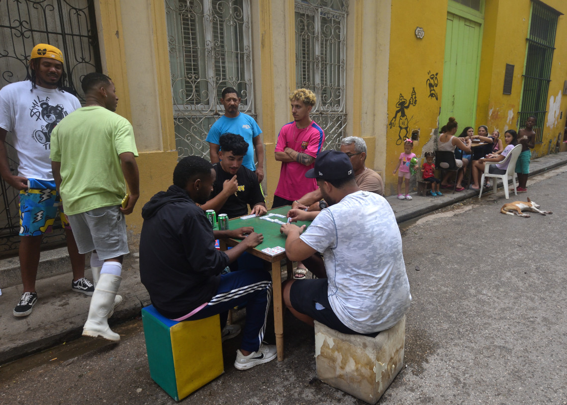 Personas juegan dominó en una calle de La Habana, un día después del azote del huracán Rafael. Foto: Otmaro Rodríguez.