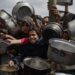 Palestinos desplazados en un comedor social en Khan Yunis, al sur de la Franja de Gaza, este viernes. EFE/ Haitham Imad.